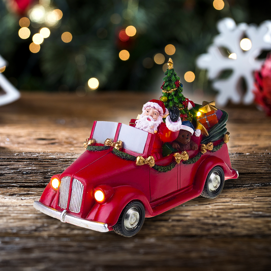 Mikołaj w samochodzie z obracającym się drzewem